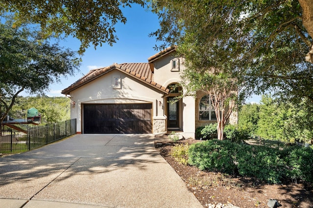 mediterranean / spanish-style home featuring a garage