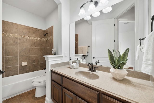 full bathroom with vanity, toilet, tiled shower / bath, and tile patterned floors