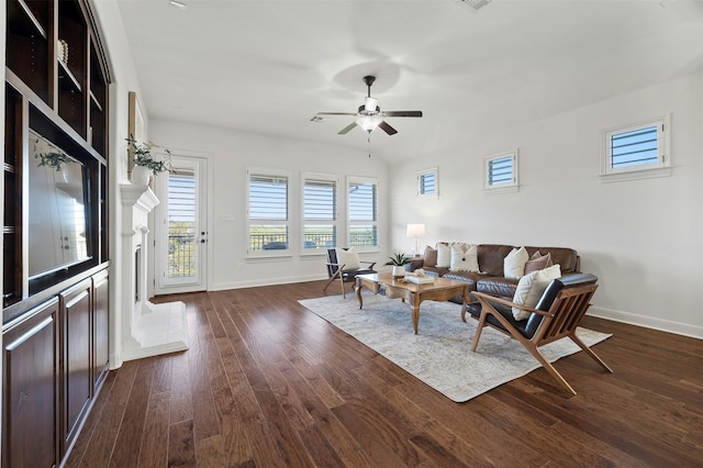 living room featuring ceiling fan and dark hardwood / wood-style flooring