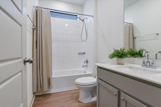 14117 Mcarthur Dr, Manor, TX 78653 - full bathroom featuring vanity, wood finished floors, shower / bath combo with shower curtain, and toilet