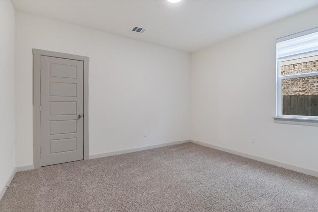 14117 Mcarthur Dr, Manor, TX 78653 - carpeted empty room with baseboards
