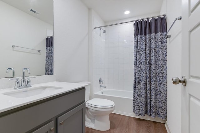 14117 Mcarthur Dr, Manor, TX 78653 - full bath featuring vanity, wood finished floors, toilet, and shower / tub combo with curtain