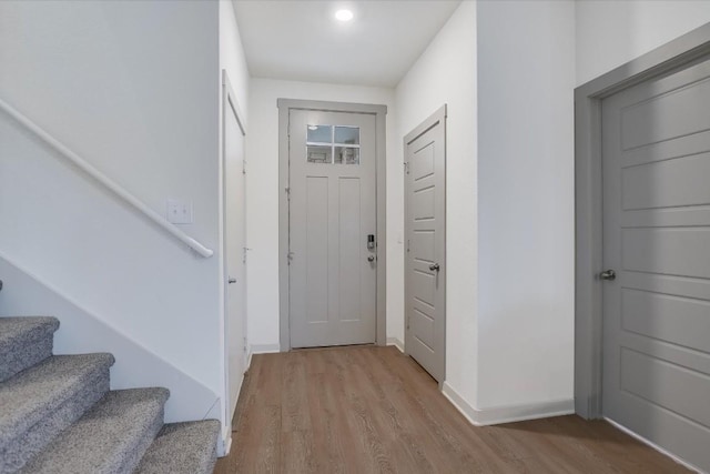 14117 Mcarthur Dr, Manor, TX 78653 - foyer entrance with wood finished floors, stairway, and baseboards