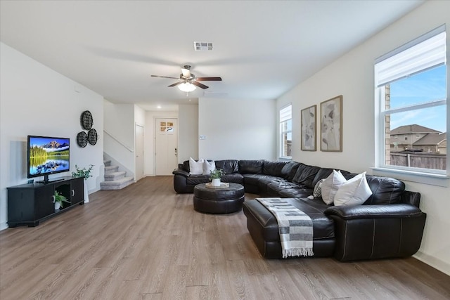 14117 Mcarthur Dr, Manor, TX 78653 - living room with light wood-style flooring, a ceiling fan, and stairway