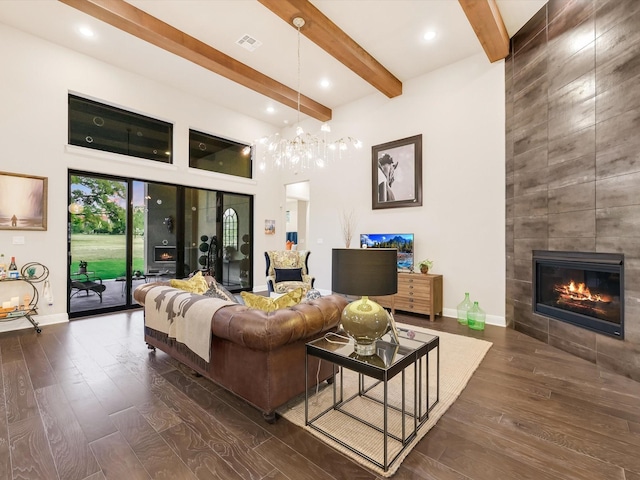 living room featuring dark hardwood / wood-style floors, a fireplace, and beam ceiling