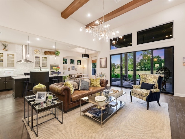 living room with sink, light hardwood / wood-style flooring, a high ceiling, beamed ceiling, and a chandelier