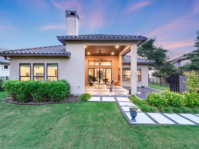 112 Blue Heron Ln, Georgetown, TX 78628 - rear view of property with a tiled roof, a patio area, stucco siding, and a chimney