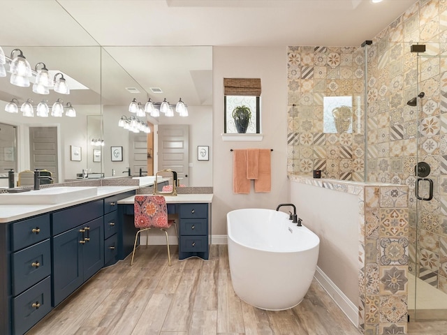 bathroom with vanity, independent shower and bath, and hardwood / wood-style floors