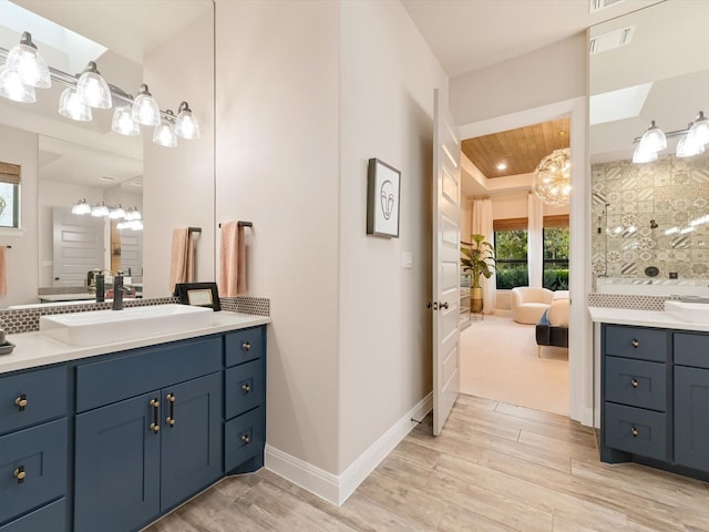 bathroom with vanity, hardwood / wood-style flooring, and wooden ceiling