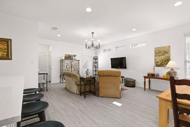 living area featuring light wood finished floors, visible vents, and recessed lighting