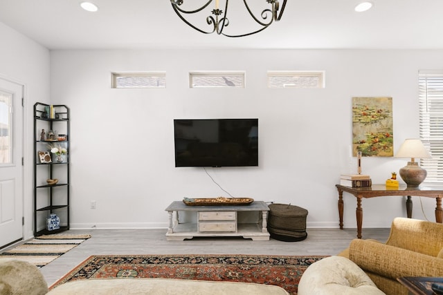 living room with baseboards, wood finished floors, and recessed lighting