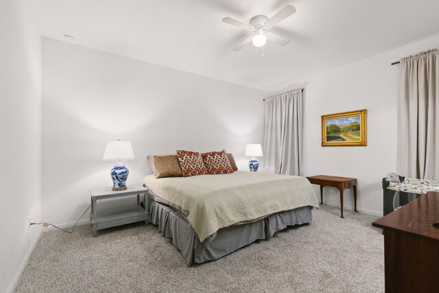 carpeted bedroom featuring a ceiling fan and baseboards