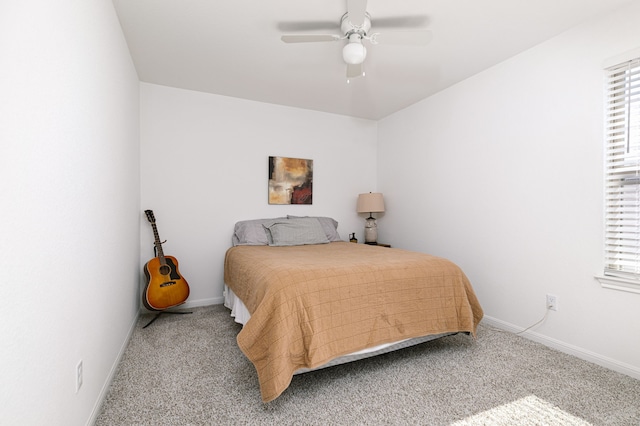 bedroom featuring multiple windows, ceiling fan, light carpet, and baseboards