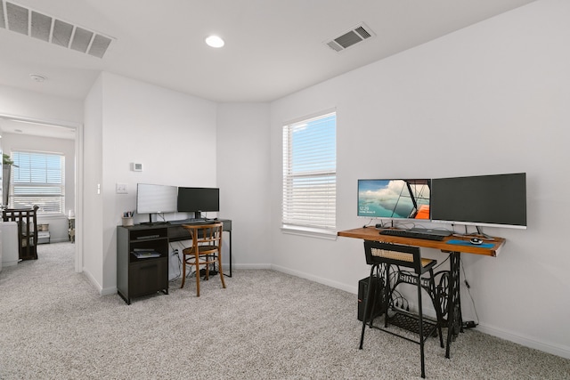 carpeted home office featuring visible vents and baseboards