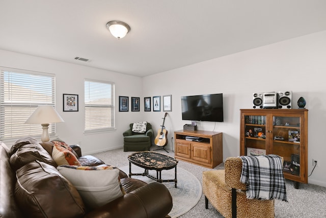 living room with light carpet, baseboards, and visible vents