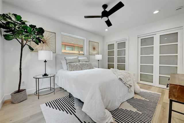 bedroom with ceiling fan and light hardwood / wood-style flooring