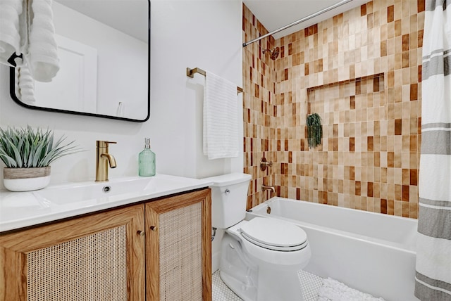 full bathroom featuring toilet, tiled shower / bath, and vanity