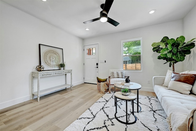 living room with ceiling fan and light wood-type flooring