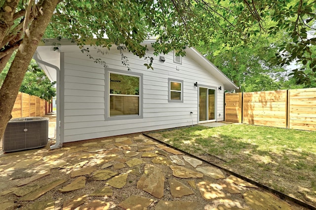 back of house with central air condition unit and a patio