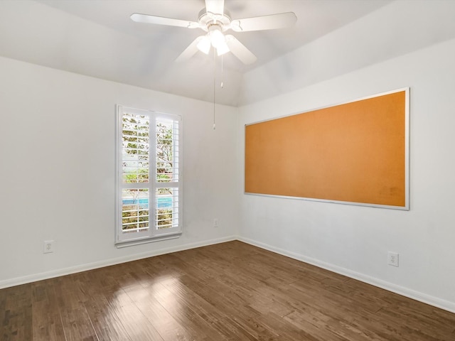 unfurnished room featuring ceiling fan, vaulted ceiling, and dark hardwood / wood-style floors