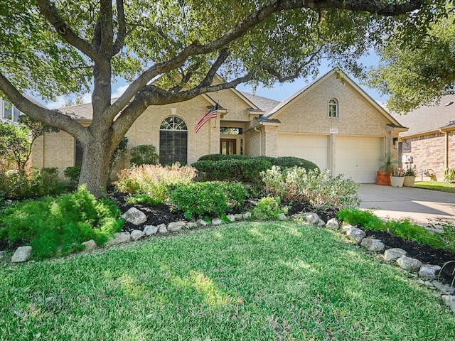 view of front of property featuring a garage and a front yard