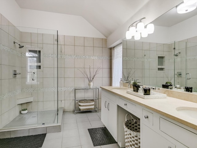 bathroom featuring lofted ceiling, vanity, tile walls, and tile patterned floors