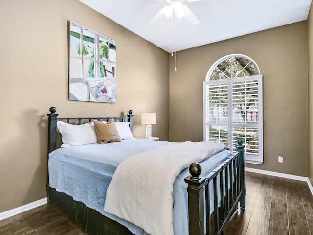 bedroom with ceiling fan and dark hardwood / wood-style flooring