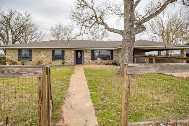 ranch-style house featuring a front lawn