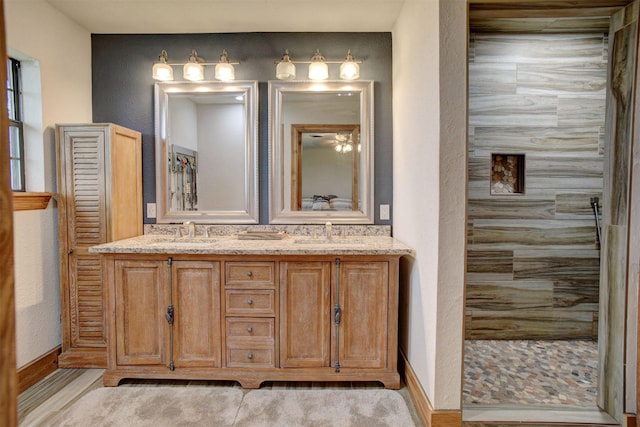 bathroom featuring walk in shower and vanity