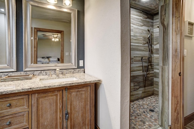 bathroom with a shower with shower door and vanity