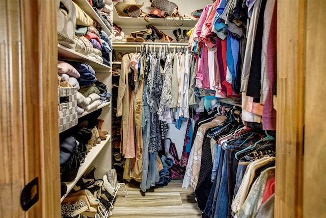 walk in closet featuring light hardwood / wood-style flooring