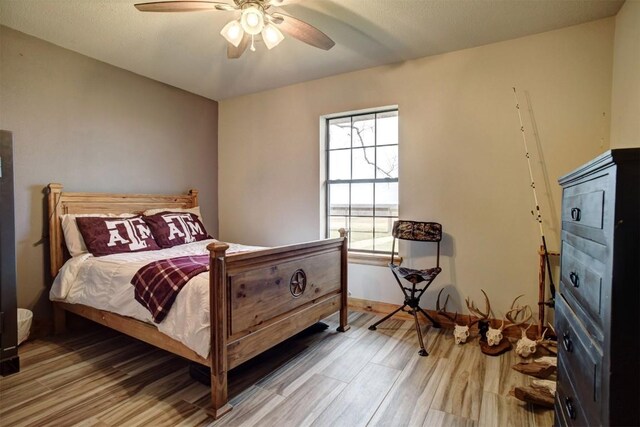 bedroom with ceiling fan and hardwood / wood-style flooring