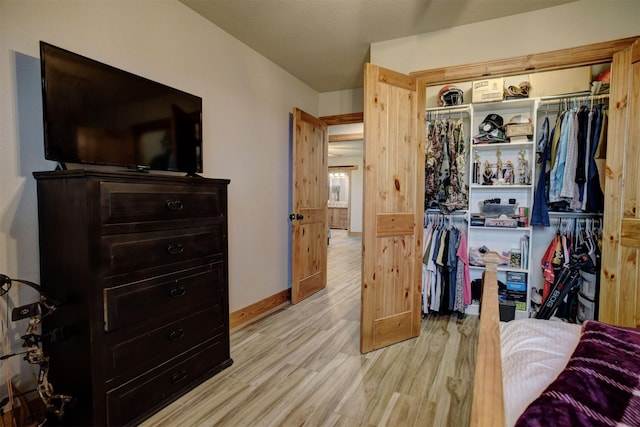 bedroom with a closet and light hardwood / wood-style flooring