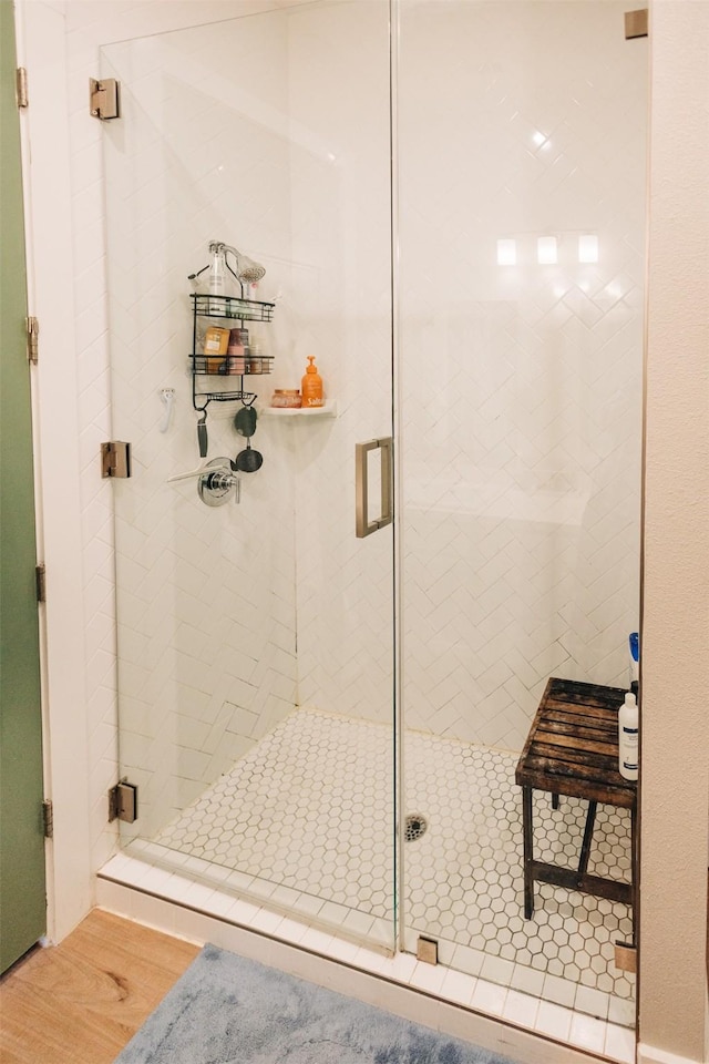 bathroom featuring hardwood / wood-style flooring and walk in shower