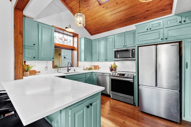 112 Center Cove Iii Loop, Spicewood, TX 78669 - kitchen featuring stainless steel appliances, a peninsula, light countertops, wooden ceiling, and tasteful backsplash