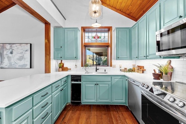 kitchen featuring wood ceiling, stainless steel appliances, decorative light fixtures, vaulted ceiling, and sink