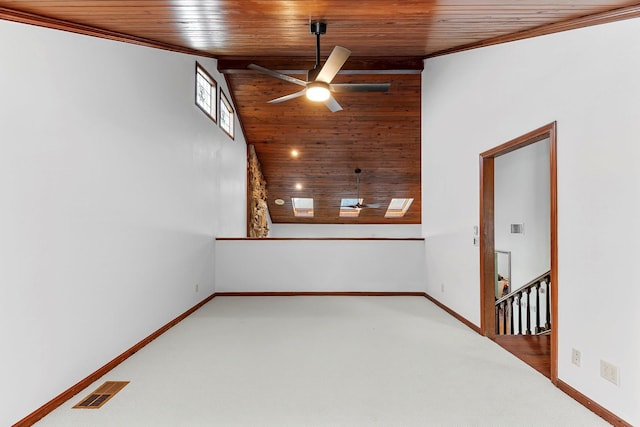 empty room featuring ceiling fan, light colored carpet, a towering ceiling, and wooden ceiling