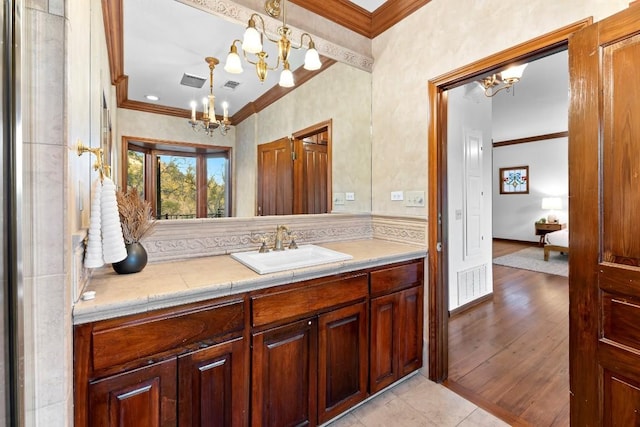 112 Center Cove Iii Loop, Spicewood, TX 78669 - bathroom with a chandelier, crown molding, and vanity