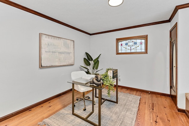 home office with crown molding and light hardwood / wood-style flooring