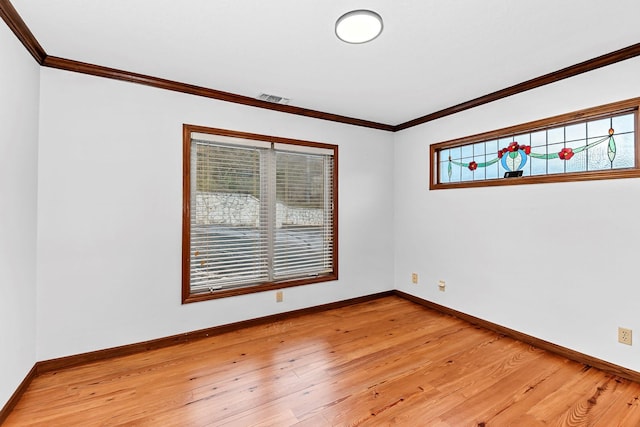 spare room featuring crown molding and wood-type flooring