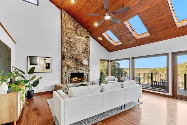 112 Center Cove Iii Loop, Spicewood, TX 78669 - living room featuring high vaulted ceiling, ceiling fan, a skylight, a fireplace, and wood ceiling