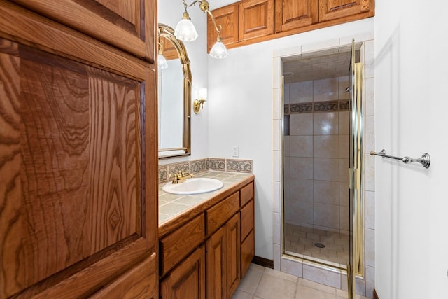 bathroom featuring an enclosed shower, vanity, and tile patterned flooring