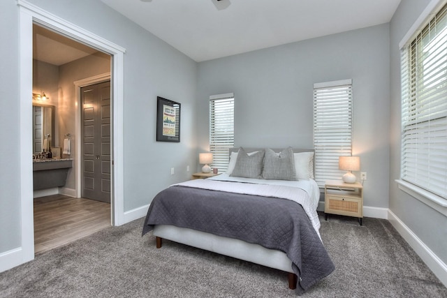 bedroom with carpet floors, ensuite bath, and ceiling fan