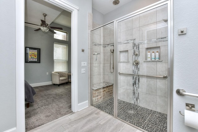 bathroom with ceiling fan and a tile shower