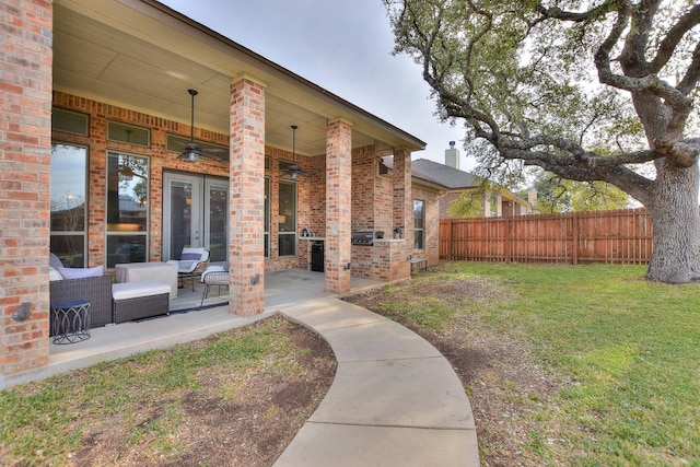 view of yard featuring ceiling fan and a patio