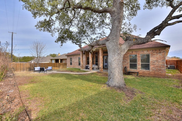 back of property with a yard and a patio