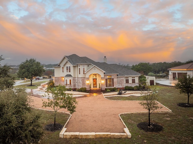 view of front of home with a lawn and french doors