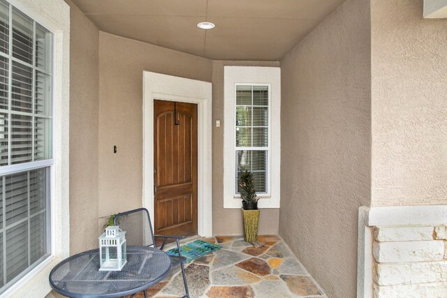 doorway to property with stucco siding