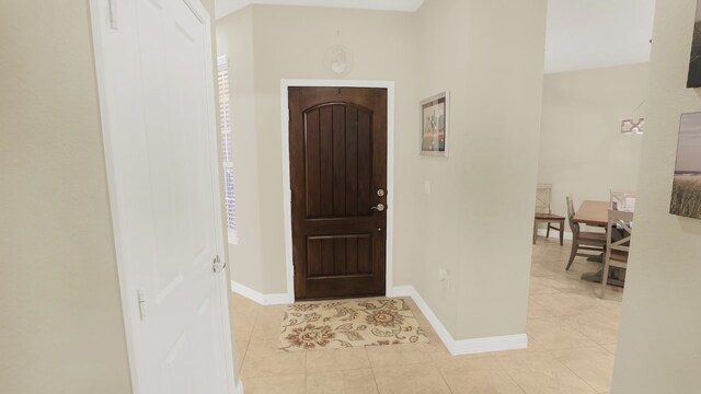 entrance foyer featuring light tile patterned floors and baseboards