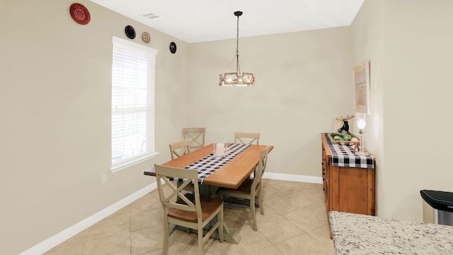 dining area featuring light tile patterned flooring, a wealth of natural light, and baseboards